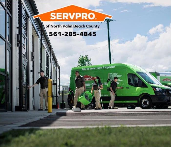SERVPRO green van with employees walking into a building.